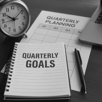 Quarterly goal setting session in a modern office, showing strategic alignment and planning among business professionals